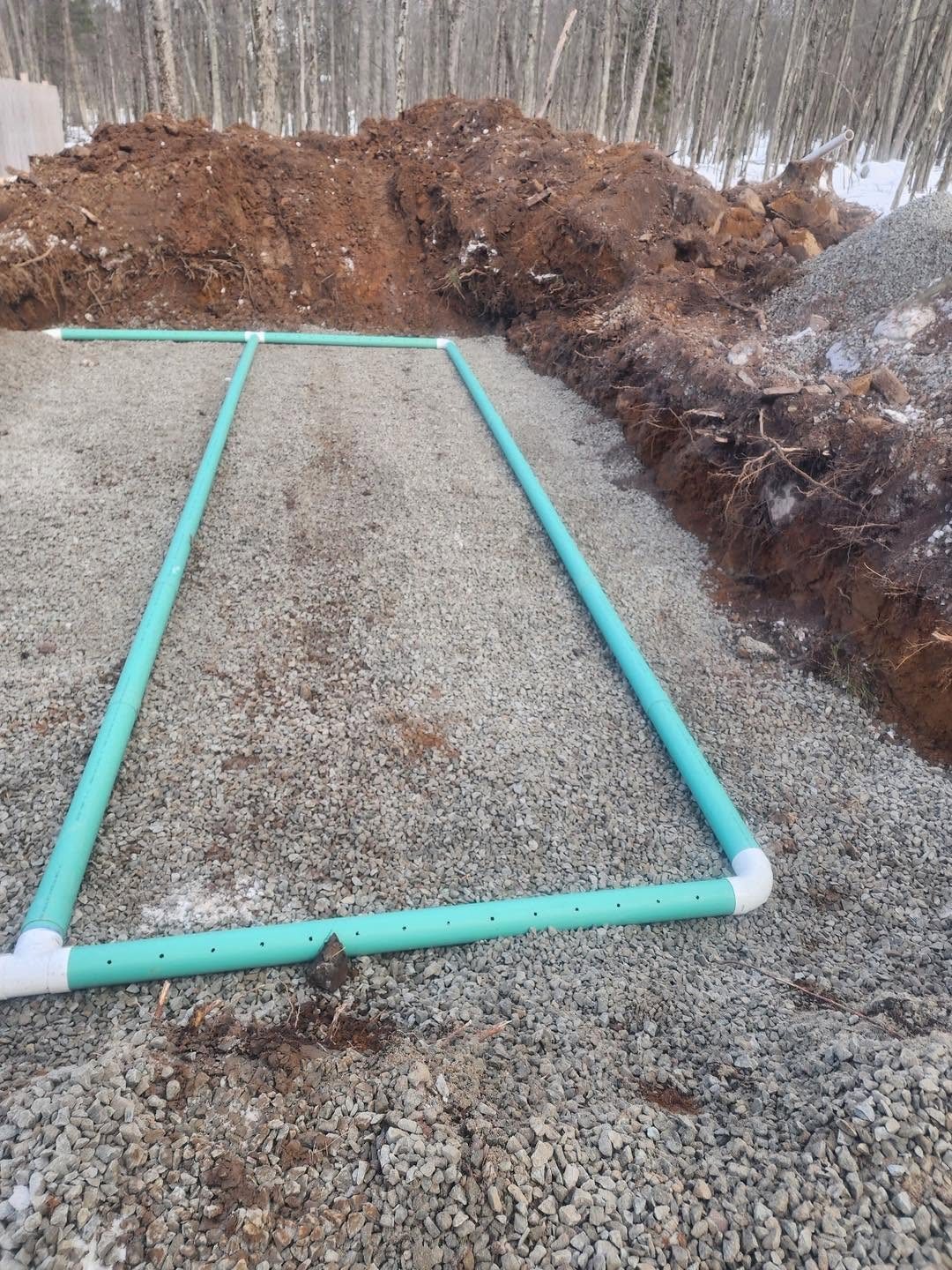 Drain field piping installed in stone bed