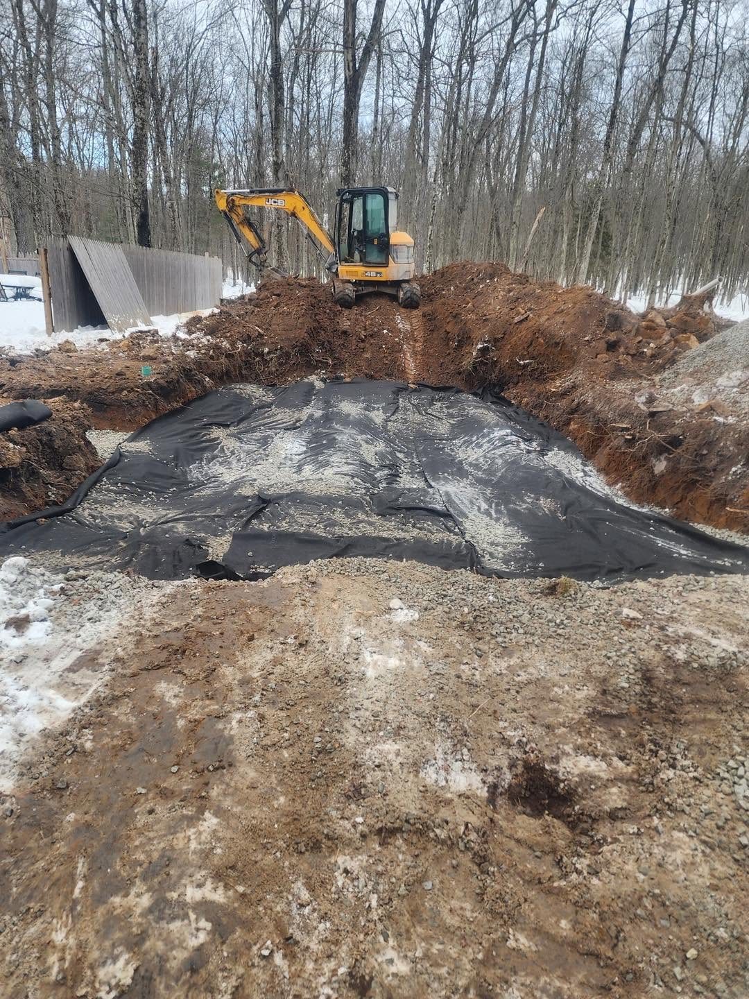 Septic repair area being prepared with stone and piping