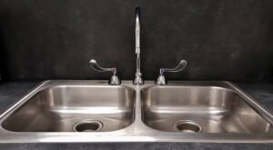 a double sink showing the faucet